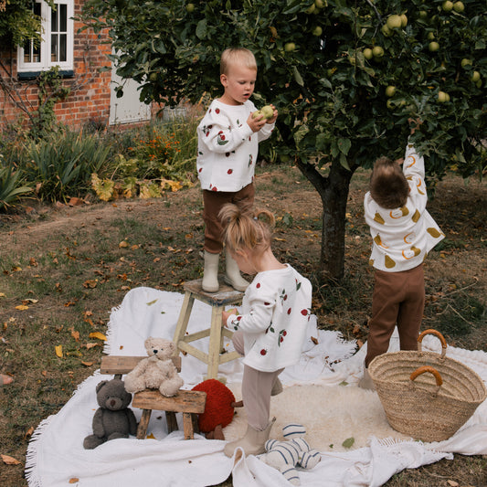 Toddlers Apple Picking in Autumn Wearing Organic Sustainable Unisex Kidswear Clothing Wildgreen Autumn Kids Outfits