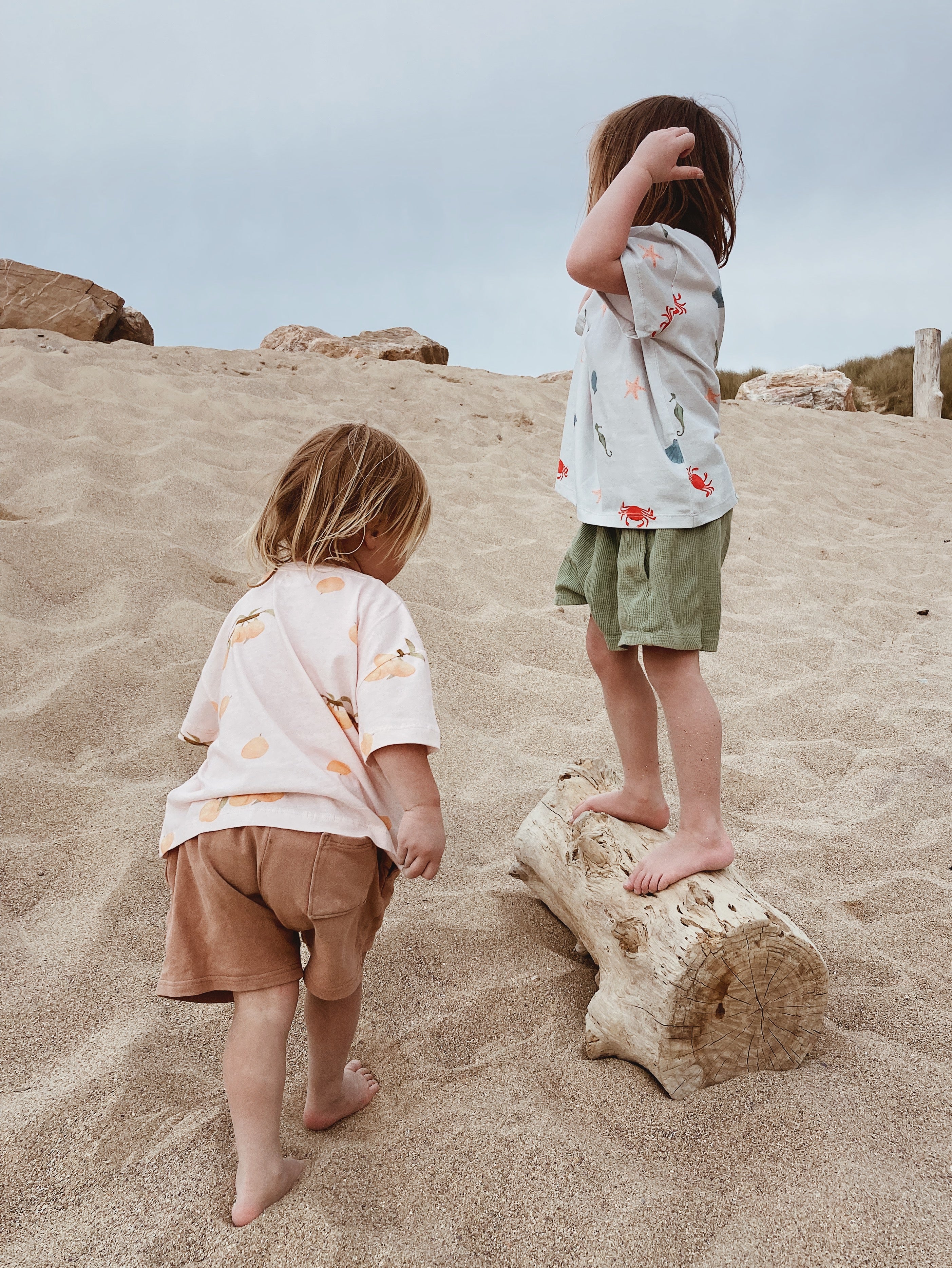 Children enjoying a beach day wearing Wildgreen’s sustainable, organic cotton clothes. Designed for comfort, movement, and muddy adventures